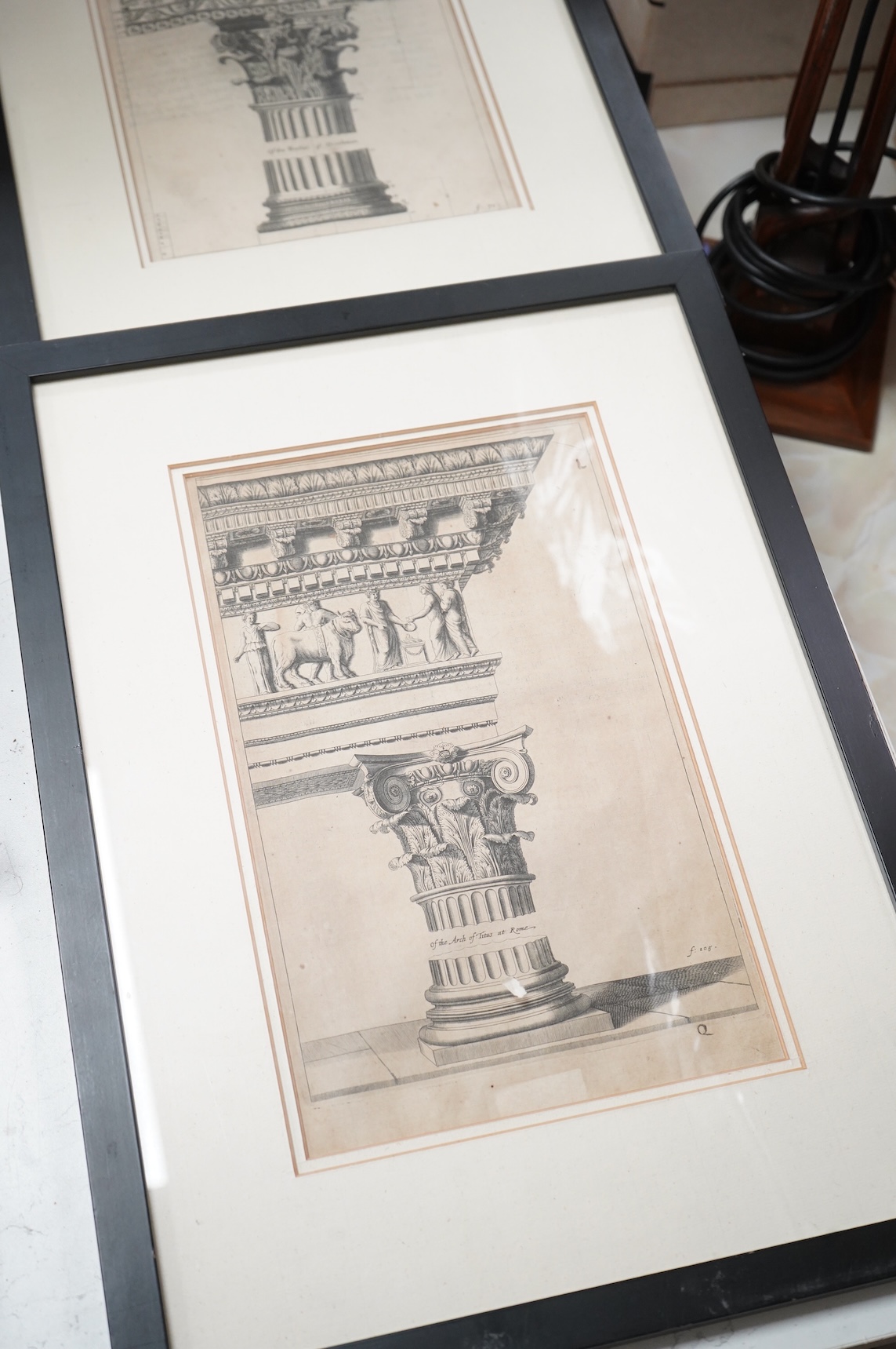 A set of four plaster plaques depicting classical scenes and four 18th/19th century architectural etchings, framed, largest 43cm high